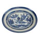 A pair of Chinese export blue and white porcelain oval dishes, decorated with pagodas in river