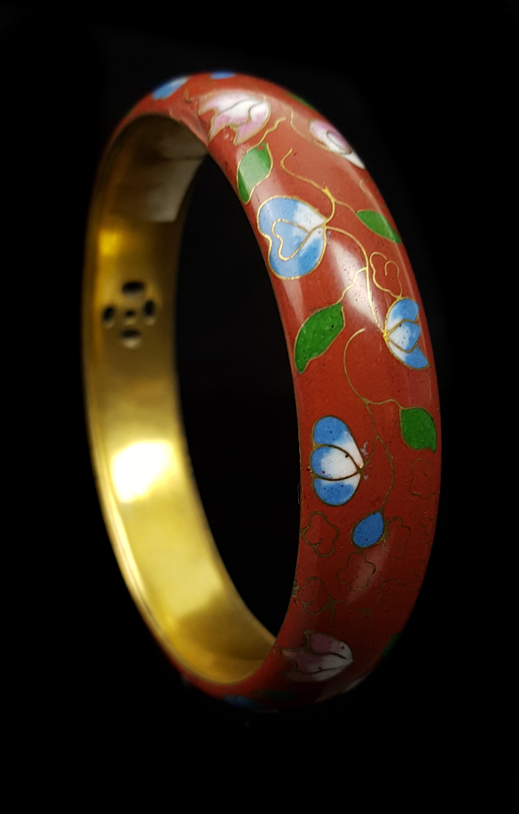 A Chinese cloisonne bangle decorated with a continuous floral garland on a claret ground, gilded - Image 2 of 2
