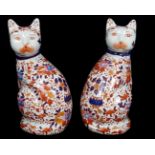 A 20th Century Chinese Imari figure of a pig; and a pair of cats, similar 25.5cm high (3)