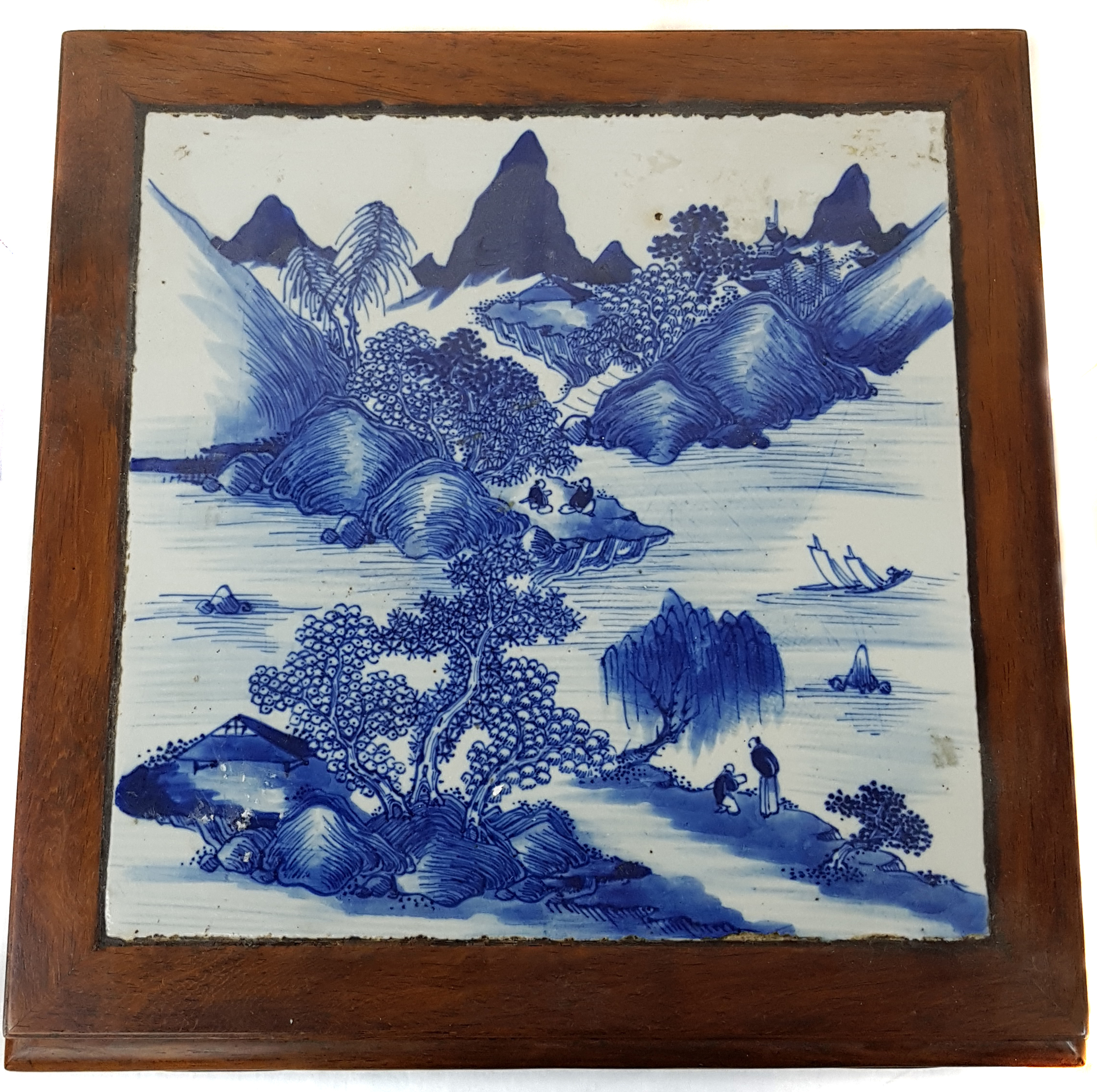 A Chinese hardwood low stand, set with a Chinese blue and white porcelain square panel to top,