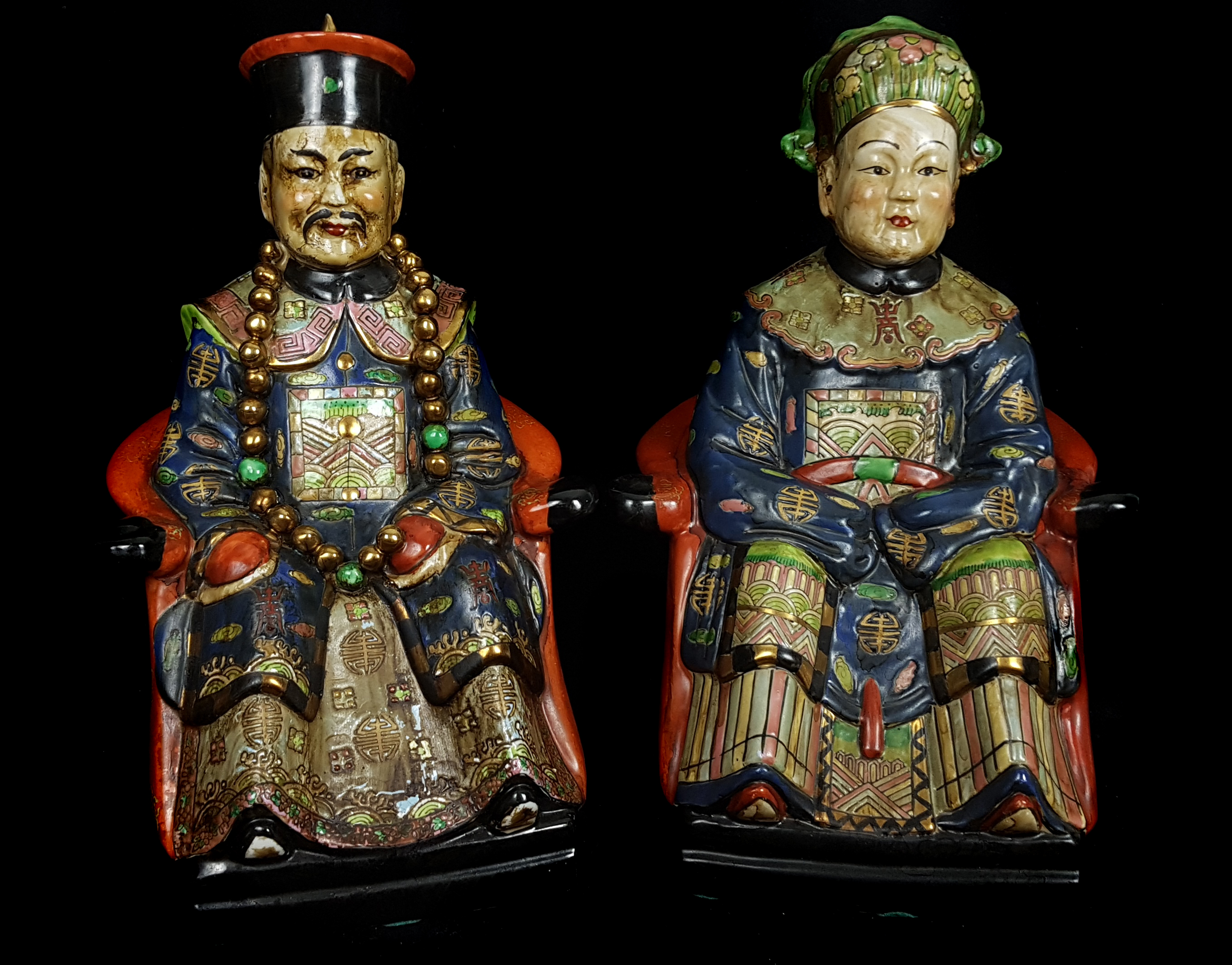 Two Chinese pottery ancestor figures, seated on thrones, polychrome decorated, 29cm high (2)