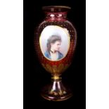 A Bohemain ruby glass vase with portrait medallion of a young girl, the ruby glass gilded overall