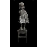A bronzed metal figure of a girl standing on a stool, 20.5cm