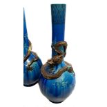 A large pair of Japanese pottery bottle vases, the necks decorated with bronzed and gilded coiled