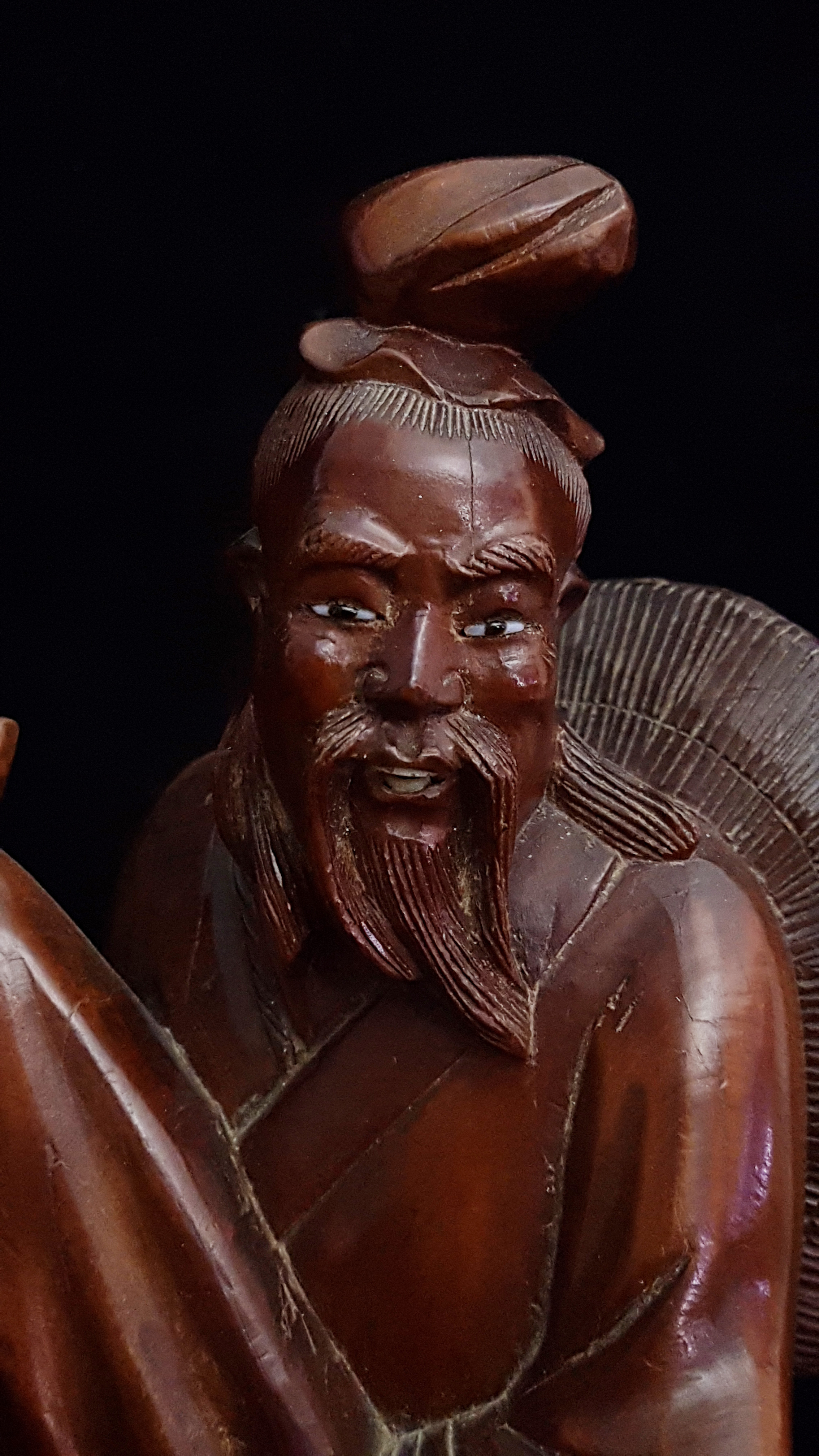 A Chinese bamboo carving of an immortal holding a large wrapped scroll, a crane to one side, eyes - Image 3 of 3