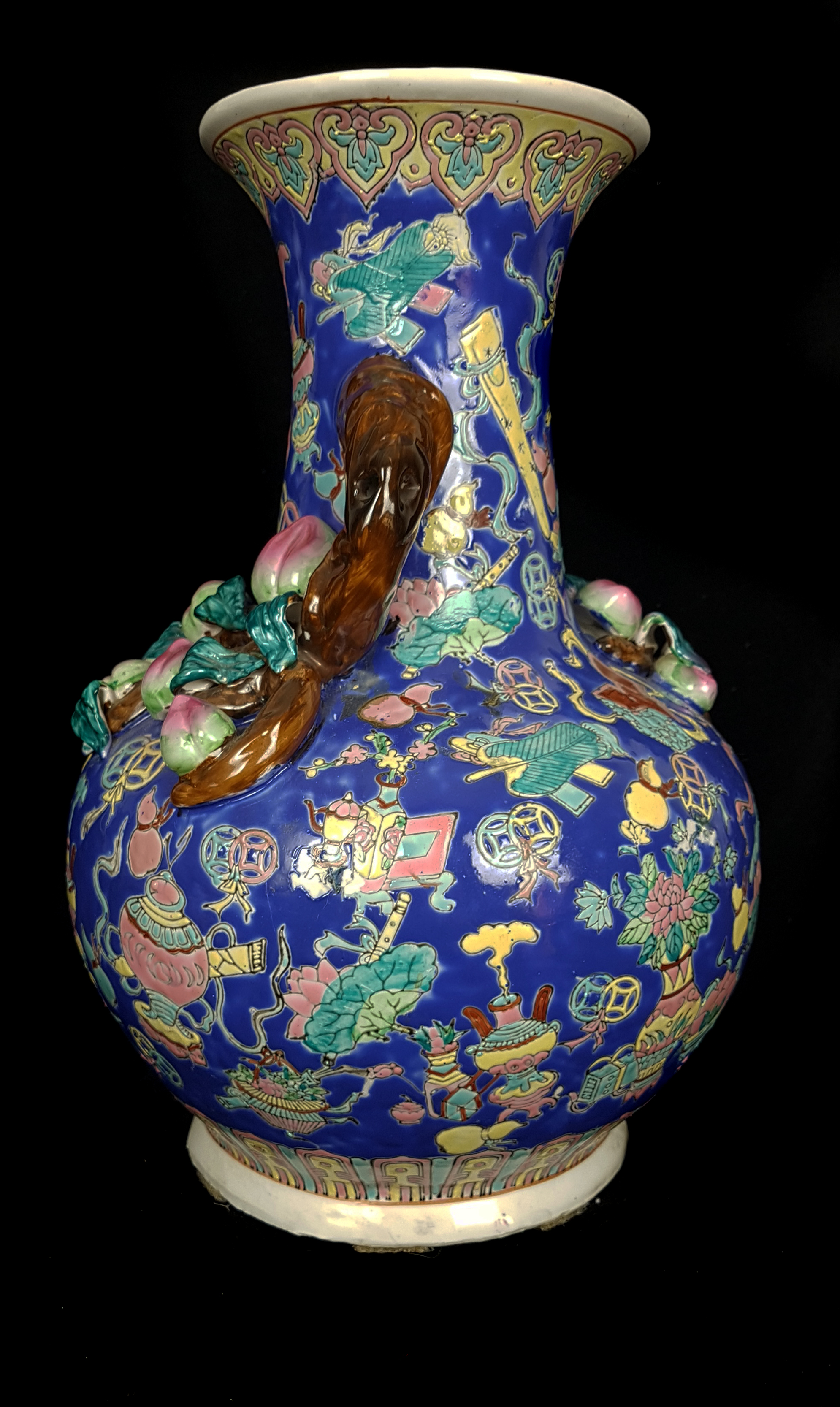 A Chinese porcelain peach vase, of squat bottle form, applied with fruiting branches, on a ground