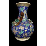 A Chinese porcelain peach vase, of squat bottle form, applied with fruiting branches, on a ground