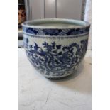A large Chinese blue and white porcelain jardiniere or fish bowl, painted with a continuous scene of