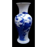 A Chinese blue and white porcelain baluster vase, painted with a bird amid flowering peony trees,