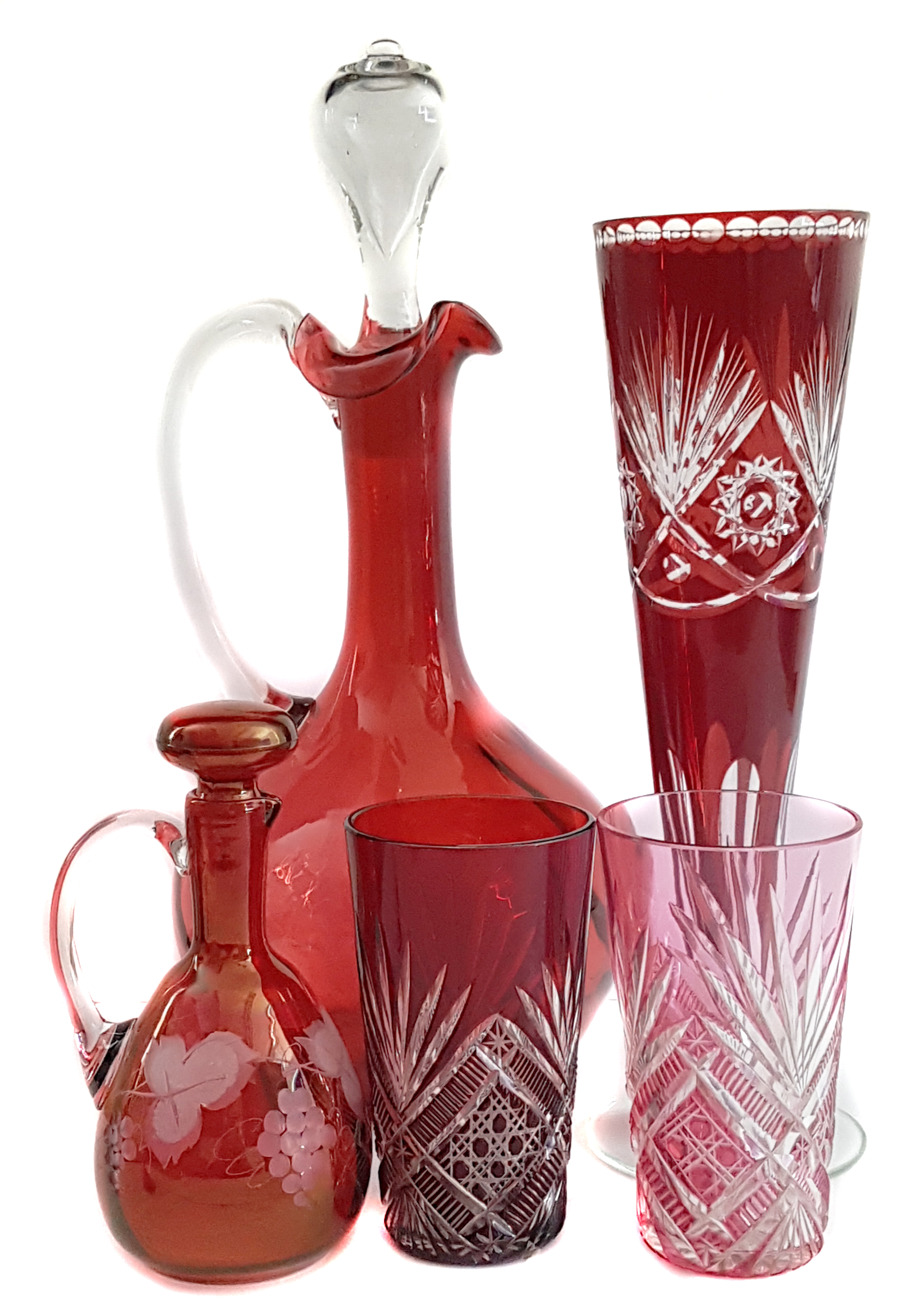 A group of ruby and cranberry coloured glasswares comprising a cranberry claret jug; two cut
