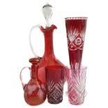 A group of ruby and cranberry coloured glasswares comprising a cranberry claret jug; two cut