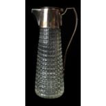 A sliver plated mounted Art Deco cut glass claret jug, the tapered cylindrical body well cut with