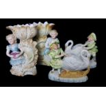 A group of German biscuit porcelain, comprising a pair of posy vases in the form of children with