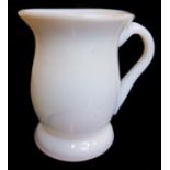 A 18thC Continental milk glass tankard, bell form on spreading foot, applied strap handle, 10.5cm