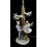 LLadro porcelain - a rare Pierrot and Ballerina figural lampbase, the figures posed around a leafy