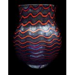 A Bohemian glass vase, possibly Kralik of squat baluster form decorated with horizontal wavy stripes