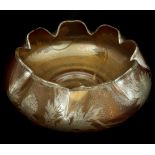 A Bohemian orange iridescent glass bowl, circular with crimped upper rim, overlaid in silver with