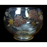 A French amber glass footed posy bowl, enamelled and gilded with flowers, grasses and leaves in