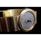 A ladies 18k Concord, quartz movement, with diamond set hour markers, bezel and 18k gold and diamond