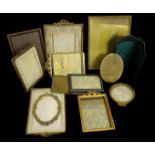 Twelve photograph frames of gilt metal and leather, many surmounted by ribbon motifs, 12cm (12)