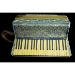 A Settimio Soprani three piano accordian, in hard case, blue nacreous decorated case (2)