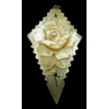 An Art Deco mother of pearl pendant carved as a lozenge with rose motif, a single pearl set to the