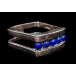 A 9ct and blue hardstone ring, the hardstone cut as 5 individual 'pearls' set in a rounded rectangle