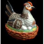 A Staffordshire pottery chicken form egg or butter box, formed as a hen sitting on eggs on an oval