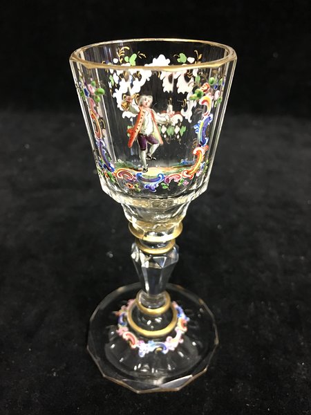 A Lobmeyr liqueur glass, delicately enamelled with an 18th Century man with bottle and glass