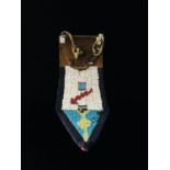 A North American Indian beadwork knife case or sheath decorated with polychrome beads on a felt,