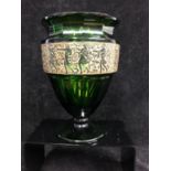 Moser - An Emerald green glass facetted urn vase, decorated with a continuous oroplastic frieze of