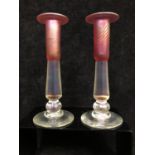 Stuart Ableman, American - A pair of studio glass candlestick, the sconces of wrythen ruby pink