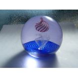 Caithness - Planet Peppermint - A glass paperweight, the white planet striped in red over a granular