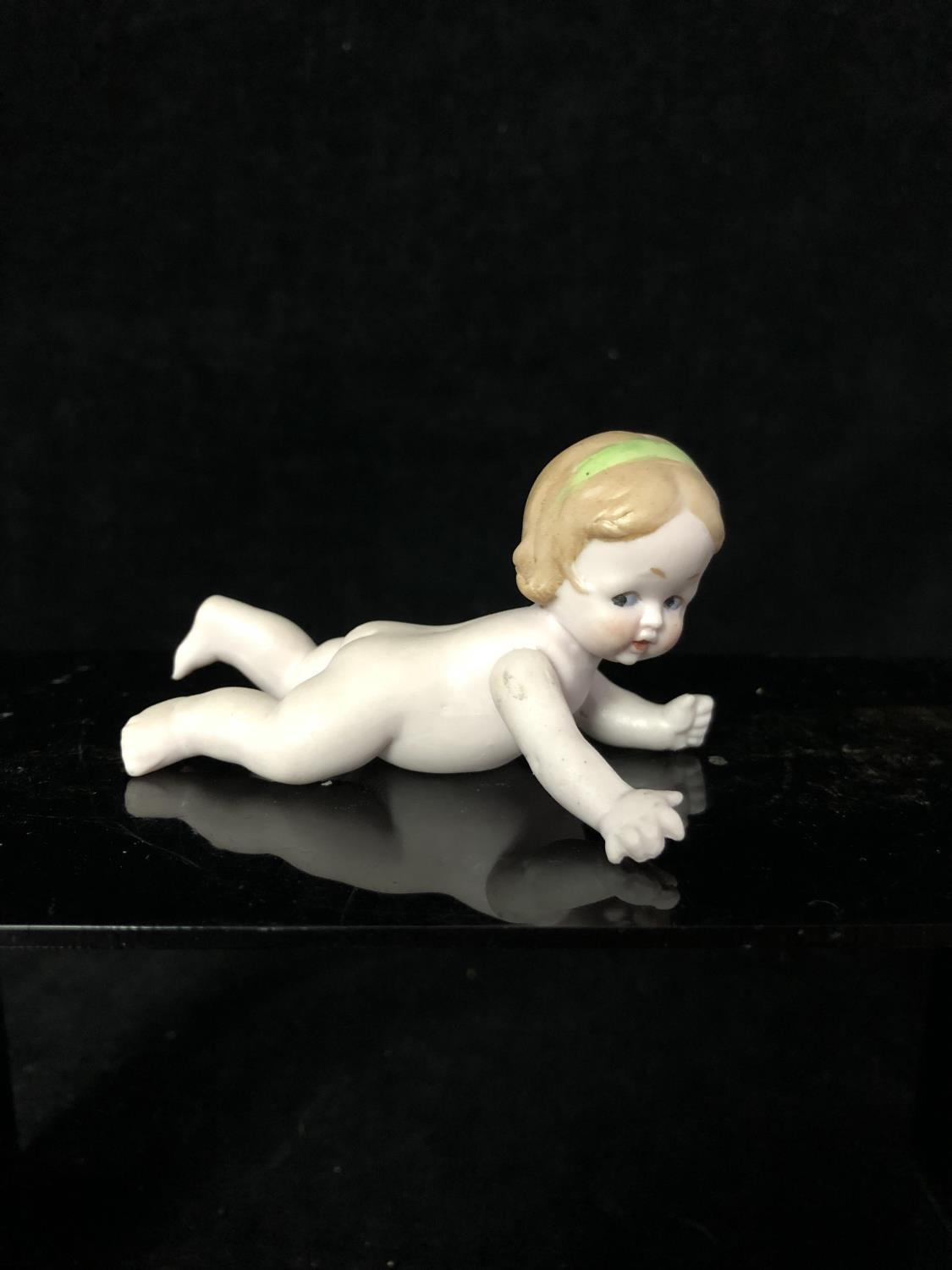 A bisque porcelain Character Child doll figure, probably Heubach Germany, modelled naked and