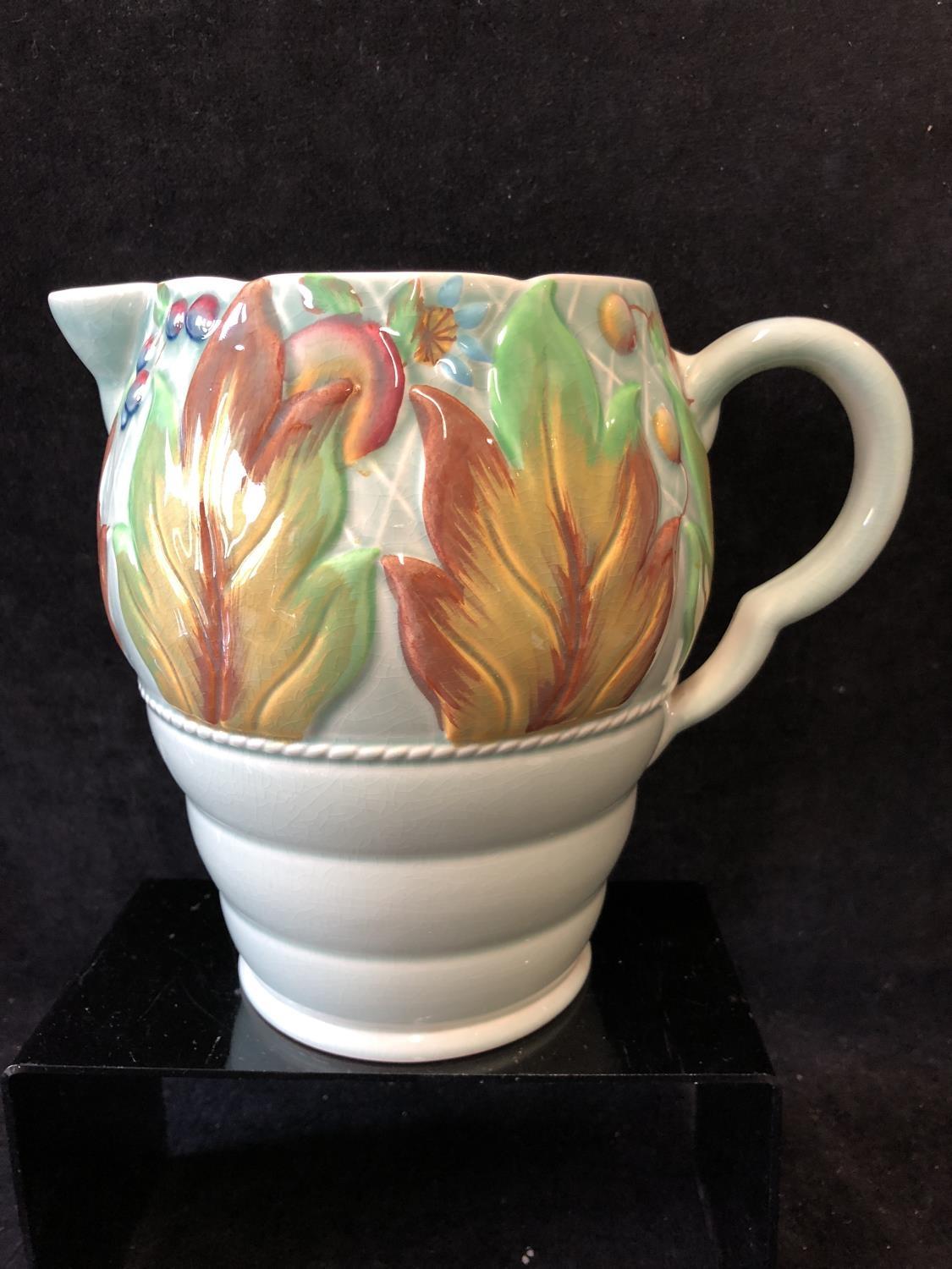 A Clarice Cliff pottery Jug, in Celtic leaf and berry pattern, jade green ground with leaves and