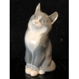 A Neilson for Royal Copenhagen Porcelain - A figure of a cat with grey coat, white bib and feet,