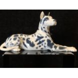 Peter Herold for Royal Copenhagen Porcelain - A Great Dane dog figure, modelled reclining, grey