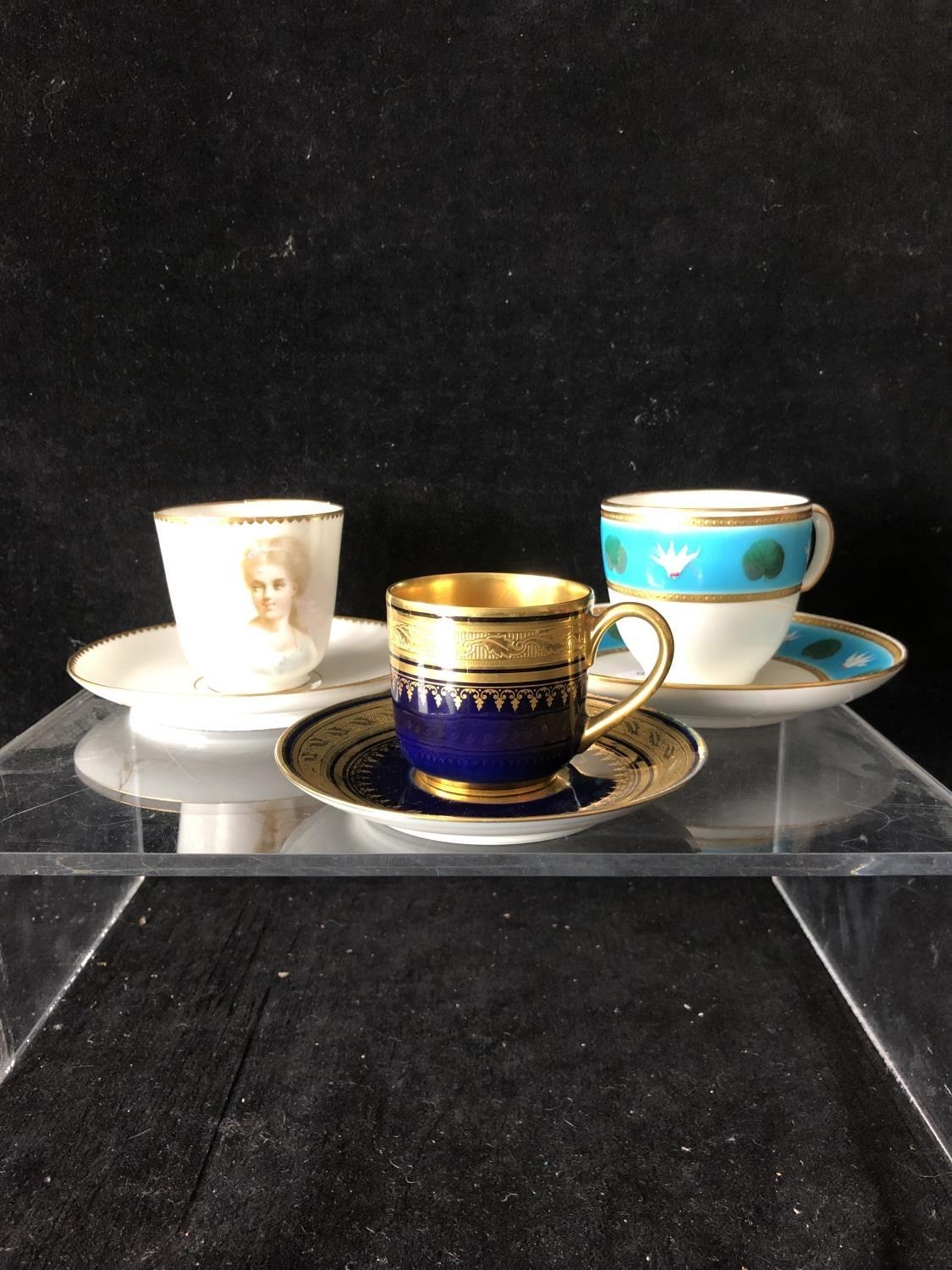 A Minton coffee cup and saucer, enamelled with cyclamen flower heads interspersed with cyclamen