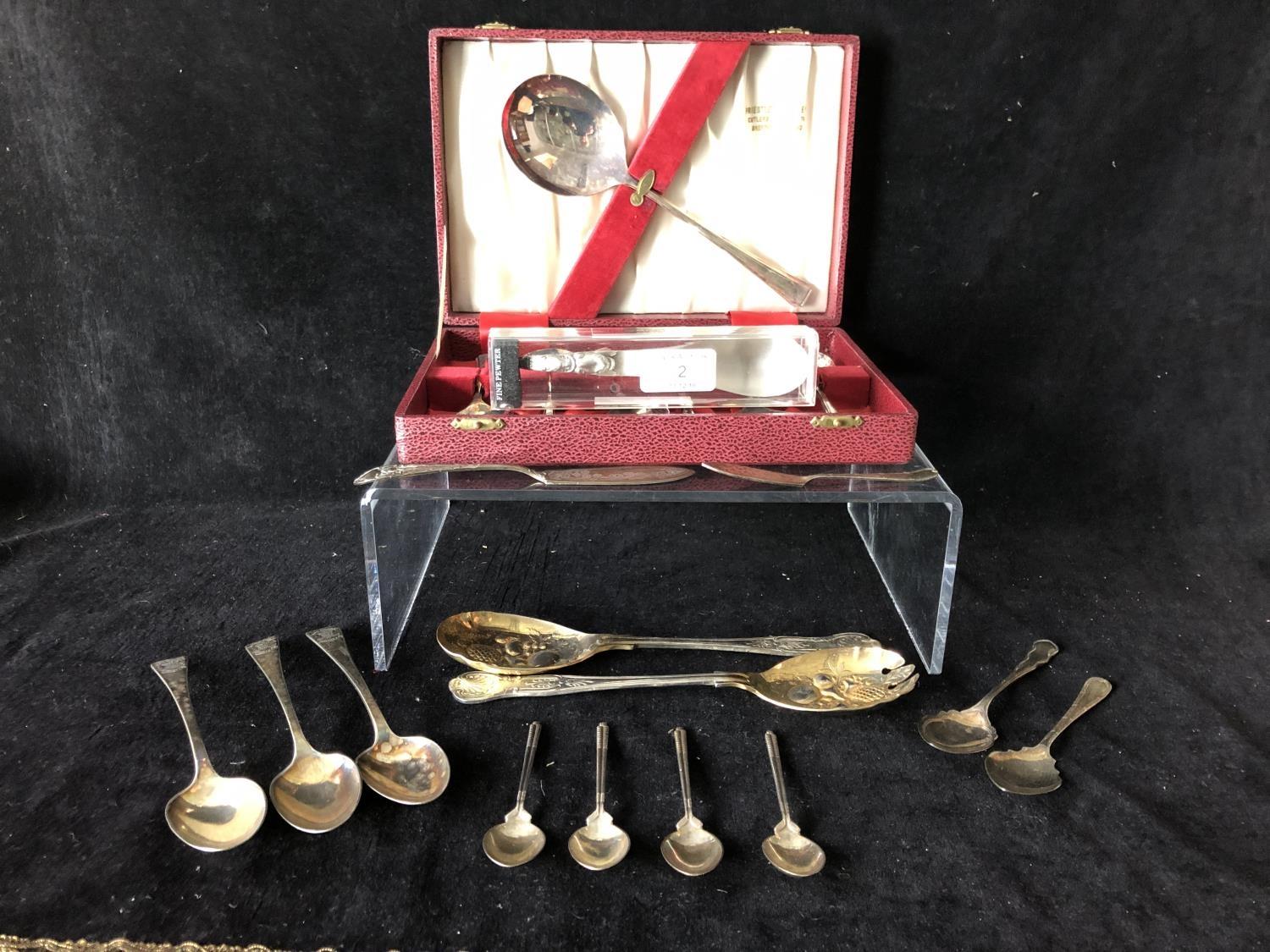 Four silver golf trophy spoons, the handles formed as a pair of golf clubs with single ball