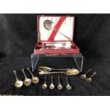 Four silver golf trophy spoons, the handles formed as a pair of golf clubs with single ball