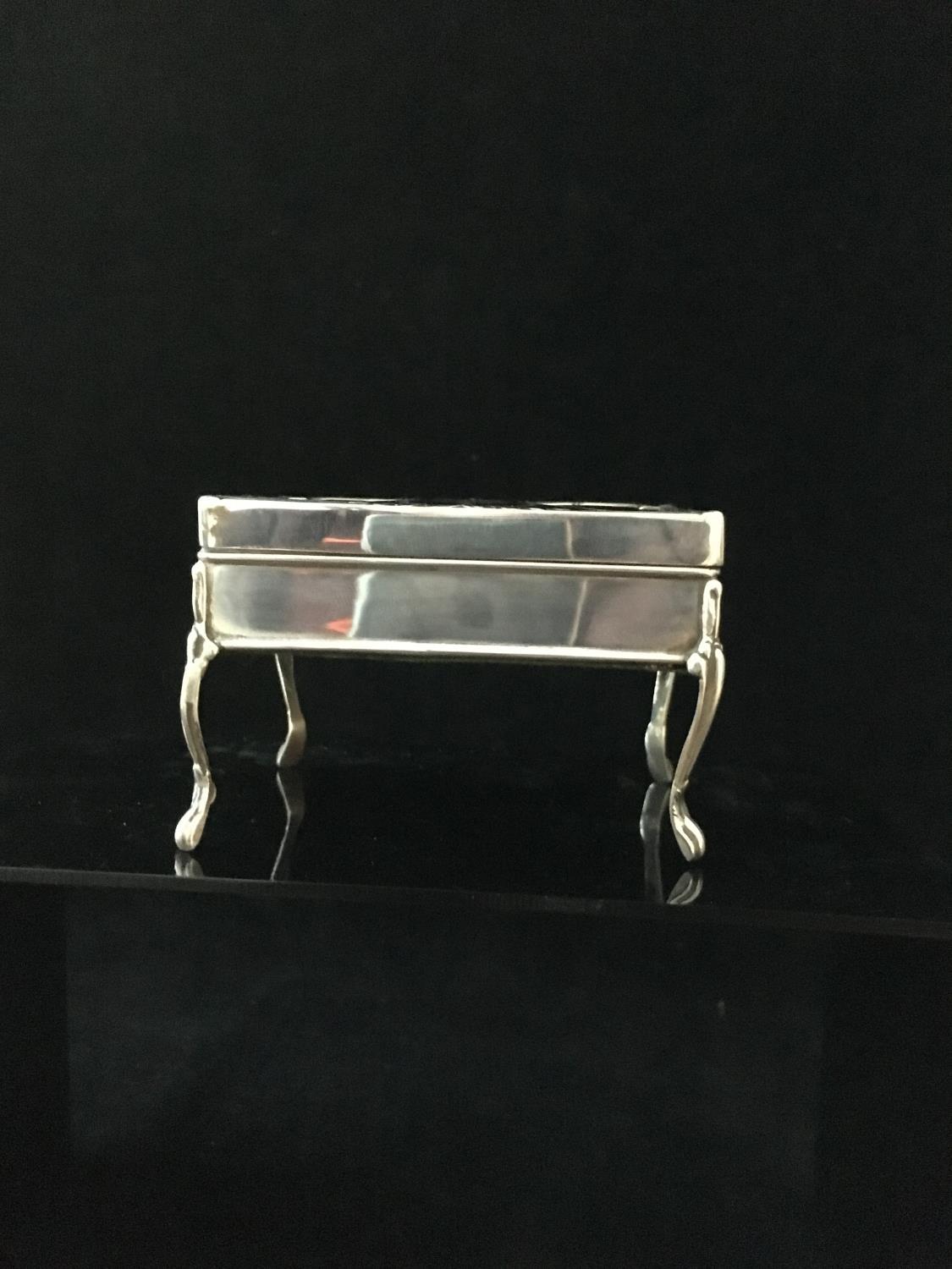 A stained horn and silver pique work box in the form of a writing table, the upper surface decorated