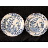 Two english Delftware plates, painted in blue with pheasant and peony pattern, chocolate brown