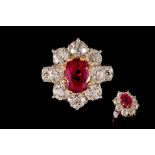 A RUBY AND DIAMOND CLUSTER RING, one cushion cut ruby of approx. 2.