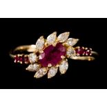 A RUBY AND DIAMOND CLUSTER DRESS RING, mounted on 18ct yellow gold,