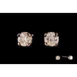 A PAIR OF DIAMOND SOLITAIRE EARRINGS, of