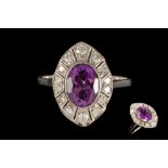 AN AMETHYST AND DIAMOND PLAQUE RING, the oval amethyst to a milligrain set diamond surround,