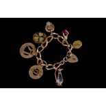 A 9CT GOLD CHARM BRACELET,