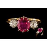 A RUBY AND DIAMOND THREE STONE RING, one cushion cut ruby of approx. 1.