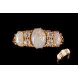 AN OPAL AND DIAMOND CARVED DRESS RING, with three oval opal cabochons of approx. 0.