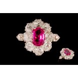 A RUBY AND DIAMOND CLUSTER RING, with one cushion cut ruby of 1.